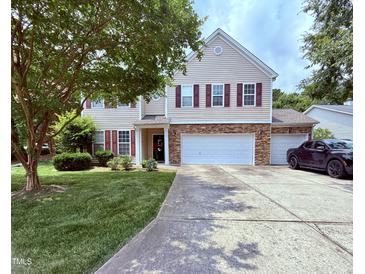 Traditional two-story home with a two-car garage, manicured lawn, and inviting curb appeal at 2228 Cedar Grove Dr, Durham, NC 27703