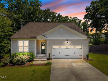 Charming single Gathering home featuring a manicured lawn and attached two car garage at 2321 Blue Crab Ct, Wake Forest, NC 27587