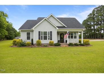 Charming single-story home with manicured lawn, tasteful landscaping, and an inviting covered porch at 416 Fred Tew Rd, Dunn, NC 28334