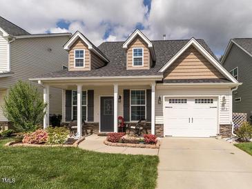 Charming home featuring dormers, a covered porch, and a well-manicured front yard at 4179 Dunkirk Dr, Burlington, NC 27215