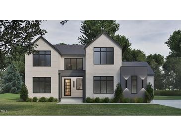 Striking two-story home boasts a brick facade, modern black-trimmed windows, and a welcoming entrance at 429 Shinleaf Pond Trl, Raleigh, NC 27614