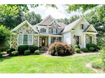 Charming home with stone accents, manicured lawn, and inviting front porch at 5920 Two Pines Trl, Wake Forest, NC 27587