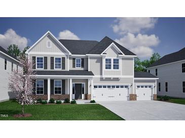 Charming two-story home featuring a three-car garage, covered front porch, and well-maintained landscaping at 75 Guardian St, Youngsville, NC 27596