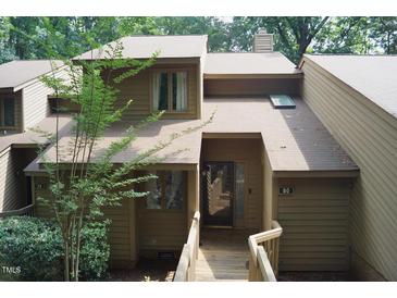Inviting two-story home with wooden porch and walkway leading to the front door at 80 Stoneridge Rd, Durham, NC 27705