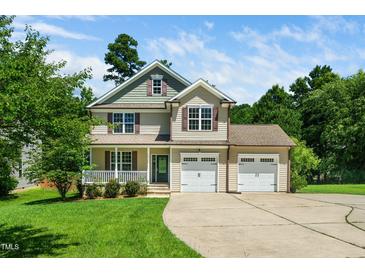 Inviting two-story home featuring a welcoming front porch and a spacious two-car garage at 11612 Leesville Rd, Raleigh, NC 27613