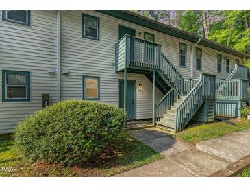 A pleasing two-story condo building features green stairs and light-colored siding at 205 Ashley Forest Rd # Bldg D, Chapel Hill, NC 27514