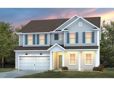 Charming two-story home featuring a welcoming front porch, complemented by blue shutters and a well-manicured lawn at 3205 Pelican Ln, Durham, NC 27703