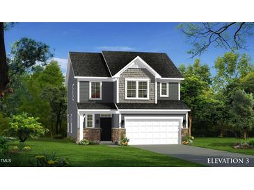 Charming two-story home with stone accents, attached two-car garage, and well-maintained landscaping at 503 Hipwood Dr, Zebulon, NC 27597