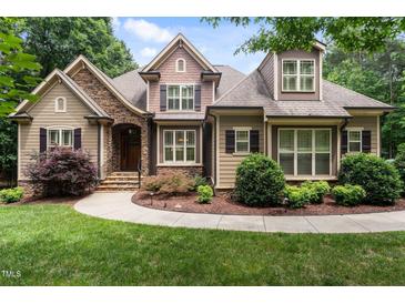 Charming exterior of a two-story home with stone accents, manicured landscaping, and a welcoming walkway at 512 Belmont Cir, Wake Forest, NC 27587