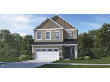 Charming two-story home featuring a two-car garage, stone accents, and a classic design at 128 Corapeake Way, Apex, NC 27539