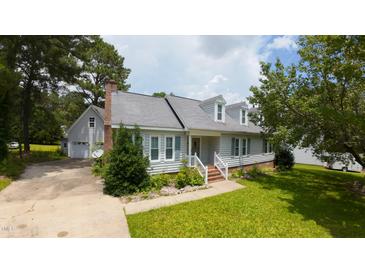Charming home featuring a well-manicured lawn, dormer windows, and a welcoming entrance at 2016 Cypress Ct, Clayton, NC 27520