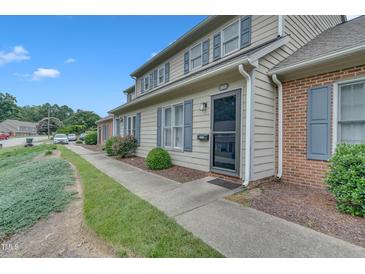 A charming townhouse featuring a well-maintained lawn and inviting front entrance at 2602 Hitchcock Dr, Durham, NC 27705
