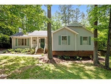 Charming single-Gathering home with green shutters surrounded by mature trees and landscaping at 3007 Appling Way, Durham, NC 27703