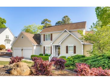 Charming two-story home with a well-manicured lawn and mature landscaping at 306 Neuse Ridge Dr, Clayton, NC 27527