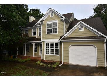 Charming two-story home featuring a two-car garage, manicured lawn, and neutral paint scheme at 3209 Leebrook Rd, Raleigh, NC 27616