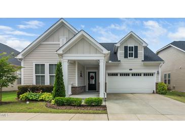 Charming single Gathering home with two-car garage, welcoming porch and manicured landscaping at 512 Courtship Cv, Durham, NC 27703