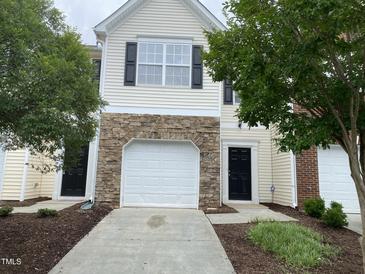 Two-story home featuring a one-car garage with stone accents and a manicured front yard at 545 Writers Way, Morrisville, NC 27560