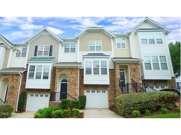 Charming townhome with stone accents, attached garages, and inviting curb appeal at 5916 Longeria Ct, Raleigh, NC 27612