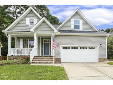 Charming home featuring a well-manicured lawn, covered porch, and two-car garage, blending comfort and curb appeal at 853 Bluffcreek Dr, Fuquay Varina, NC 27526