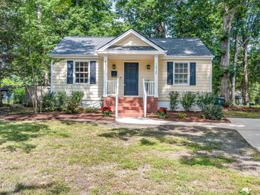 Charming home featuring a welcoming front porch, tasteful landscaping, and classic architectural details at 1825 Watkins St, Raleigh, NC 27604
