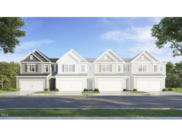 Charming new townhome construction with attached garages and welcoming curb appeal at 2019 Nebula Way, Durham, NC 27703