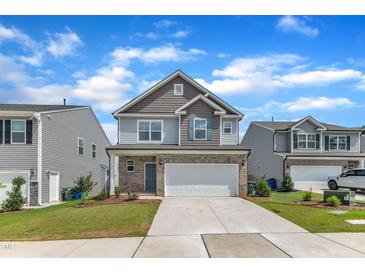 Charming two-story home featuring a two-car garage and manicured front lawn at 3505 Triad Ct, Raleigh, NC 27604