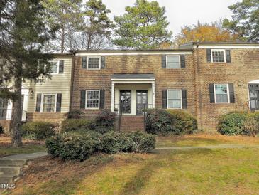 Brick townhouse with black shutters and landscaping at 3738 Jamestown Cir, Raleigh, NC 27609