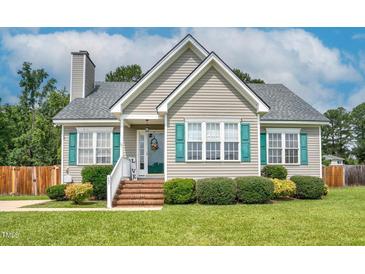 Charming single story home featuring light tan siding, a chimney, and a well maintained front yard at 402 Hearthstone Dr, Nashville, NC 27856