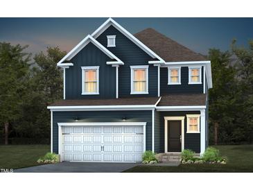 Two story home featuring board and batten siding, a two car garage, and a covered entry at 529 Prestonfield Way, Raleigh, NC 27603
