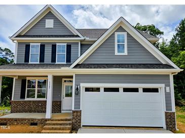 Charming two-story home with gray siding, black shutters, and a spacious white two-car garage at 5905 Genesee Dr., Homesite 6, Durham, NC 27712