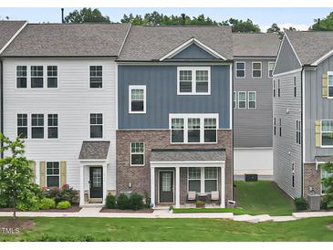 Charming townhome with a combination of siding and brick, covered porch, and well-maintained lawn at 6928 Leesville Rd, Raleigh, NC 27613