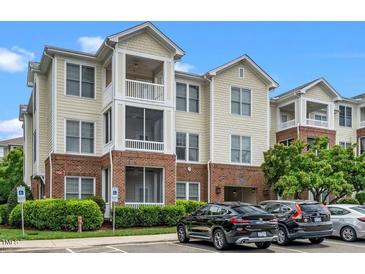 Attractive condo building featuring a blend of brick and siding, multiple balconies, and convenient parking at 734 Portstewart Dr, Cary, NC 27519