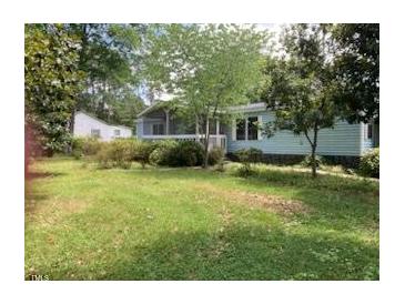 Charming single-story home with a well-maintained front yard and mature trees at 3555 Nc 98 Hwy, Youngsville, NC 27596