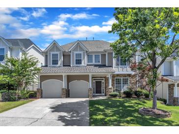 Charming two-story home featuring a two-car garage and manicured front lawn at 413 Westfalen Dr, Cary, NC 27519