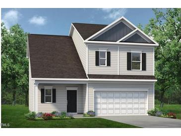 Charming two-story home with a large garage, well-manicured lawn, and classic black shutters at 62 Gray Pine Way, Sanford, NC 27332