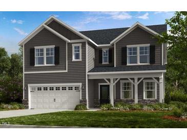 Two-story home featuring gray siding, a two-car garage, and well-maintained front lawn at 147 Rivulet Ct, Cary, NC 27519