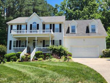 Charming two-story home featuring a welcoming front porch and beautifully landscaped yard at 18 Clover Hil Pl, Durham, NC 27712