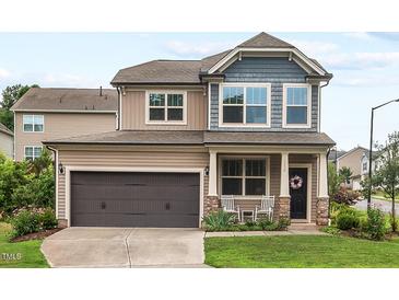 Charming two-story home with a well-manicured lawn and a two-car garage in a lovely neighborhood at 1924 Rustica Dr, Durham, NC 27713