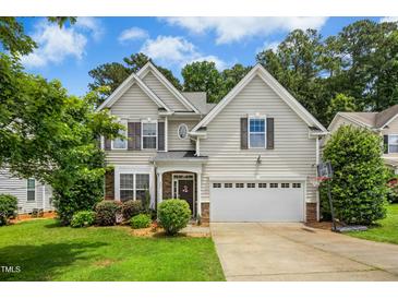 Charming two-story home featuring a well-maintained lawn, attached garage, and neutral siding for a welcoming curb appeal at 304 Forbes Rd, Wake Forest, NC 27587
