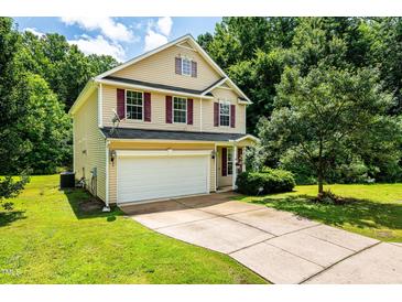 Charming two-story home with a two-car garage, red shutters, and a well-manicured lawn at 3445 Dutchman Rd, Raleigh, NC 27610