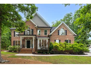 Charming brick home featuring meticulously maintained landscaping and architectural details at 3604 Thorndike Dr, Wake Forest, NC 27587