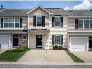 Charming townhome featuring a well-manicured lawn, black shutters, and a gray roof at 5225 Big Bass Dr, Raleigh, NC 27610