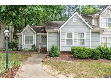 Charming home with light blue siding, a well-manicured lawn, and a welcoming walkway to the front door at 6213 Fountainhead Dr, Raleigh, NC 27609