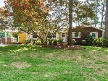 Charming single-story home featuring a well-maintained lawn, mature trees, and a welcoming facade at 100 Upton Ct, Garner, NC 27529