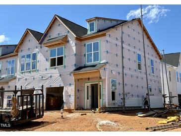 New construction home with protective wrap, featuring modern architectural details and ample window space at 107 Ripple Way # 209, Clayton, NC 27520