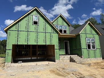 New construction home featuring a two-car garage, brick accents, and visible framework ready for customization at 152 Big Bradley Dr, Wendell, NC 27591