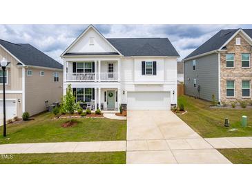 Charming two-story home featuring a double front porch and a well-maintained lawn at 222 Oak Branch - Lot 72 Trl, Garner, NC 27529