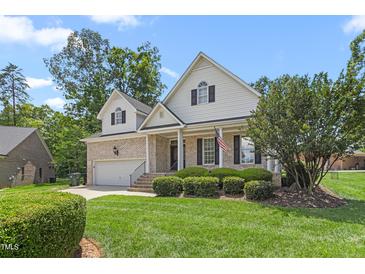 Charming two-story home with a well-manicured lawn, attached garage, and brick accents at 2333 Grey Gables Dr, Burlington, NC 27215