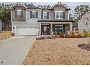 Charming two-story home with manicured lawn, two-car garage and inviting front porch at 301 Porter Hill Dr, Youngsville, NC 27596