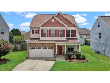 Charming two-story home featuring a stone facade, red shutters and a well-manicured lawn at 40 Horizon Trl, Garner, NC 27529
